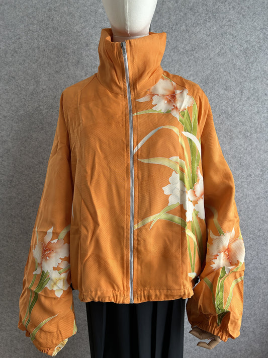 Orange high collar kimono jacket with large white flowers, front view