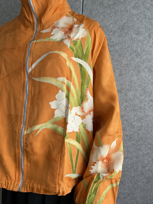 Orange high collar kimono jacket, detail of white flowers and green leaves