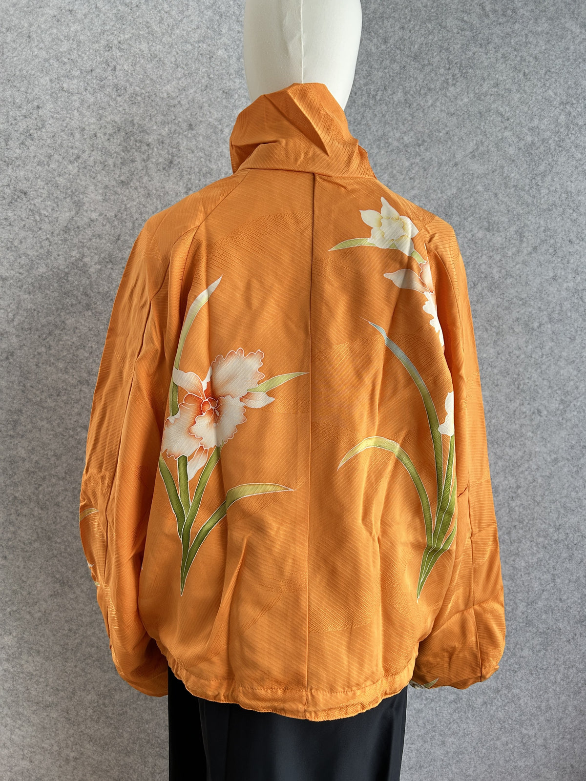 Orange high collar kimono jacket with large white flowers, back view