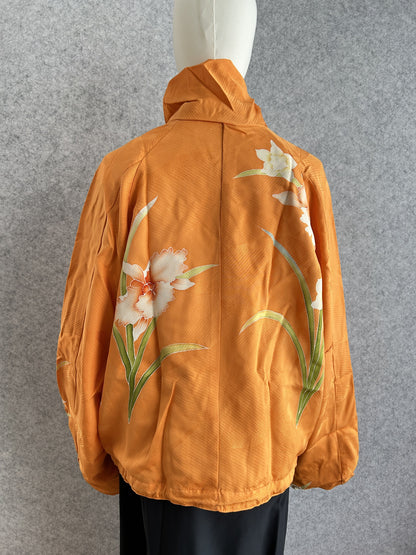 Orange high collar kimono jacket with large white flowers, back view