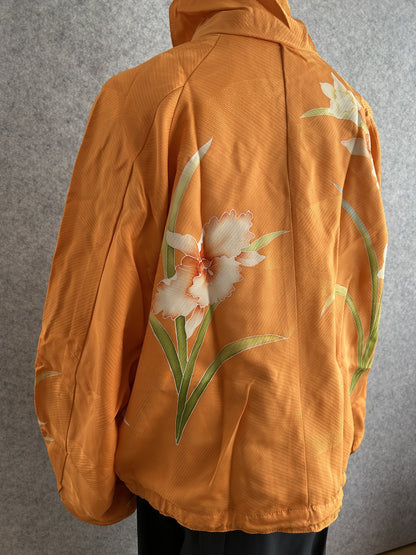 Orange high collar kimono jacket, side back view of white flower