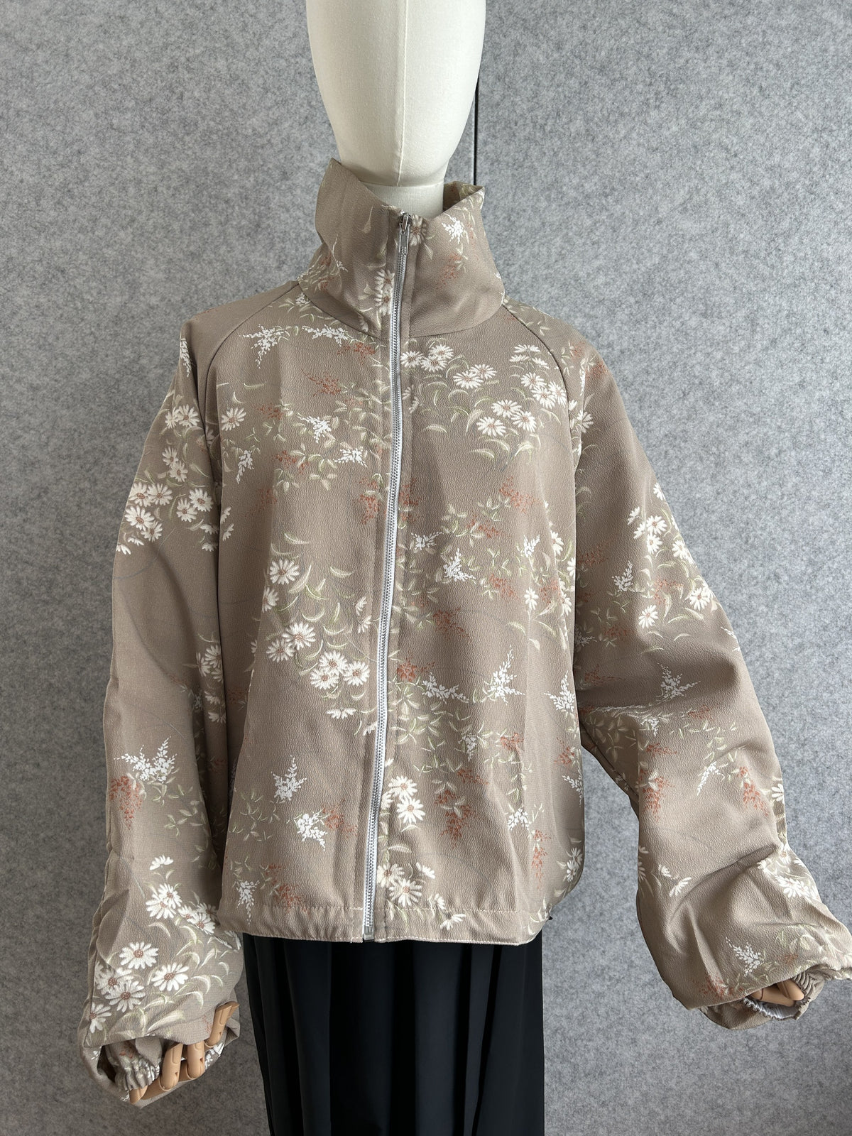 Taupe high collar kimono jacket with small white flower pattern, front view