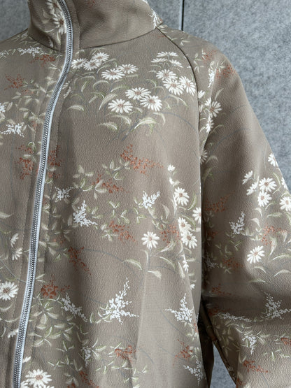 Taupe high collar kimono jacket, detail of white flowers and zipper