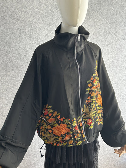 Black high collar kimono jacket with floral band, front view from the other side