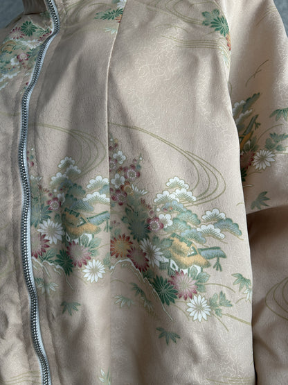 Pale beige pink high collar kimono jacket with flowers, detail of flower cluster beside the zipper