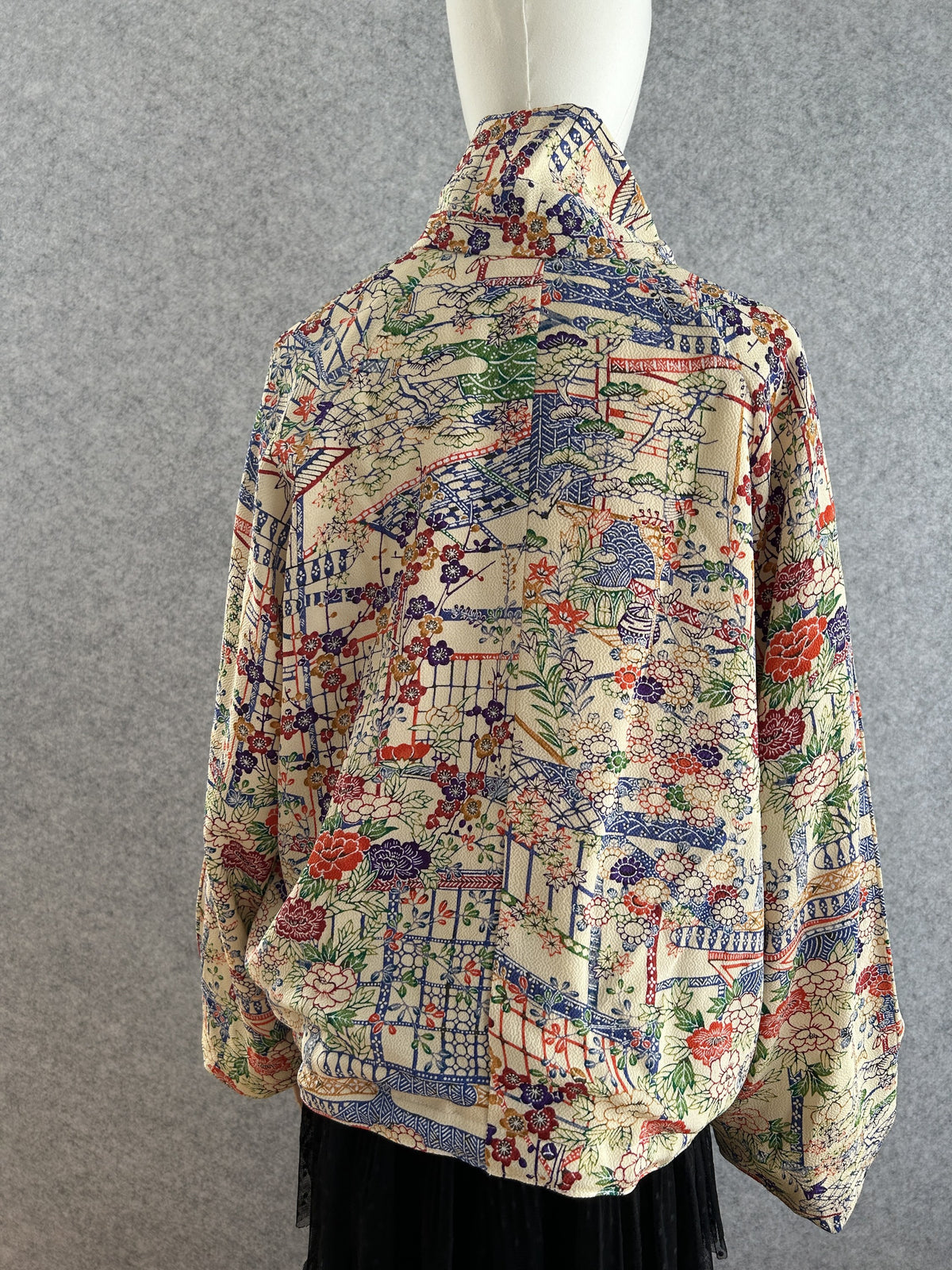 Cream high collar kimono jacket with colourful flowers, back view