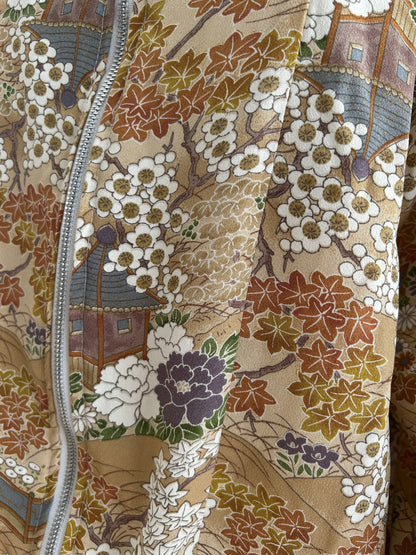 Golden beige high collar kimono jacket with blossoms, detail of blossoms and maple leaves by the zipper