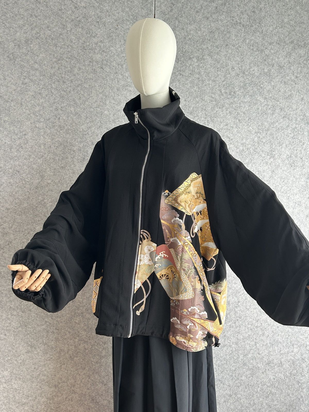 Black high collar kimono jacket with gold crane motifs, front view