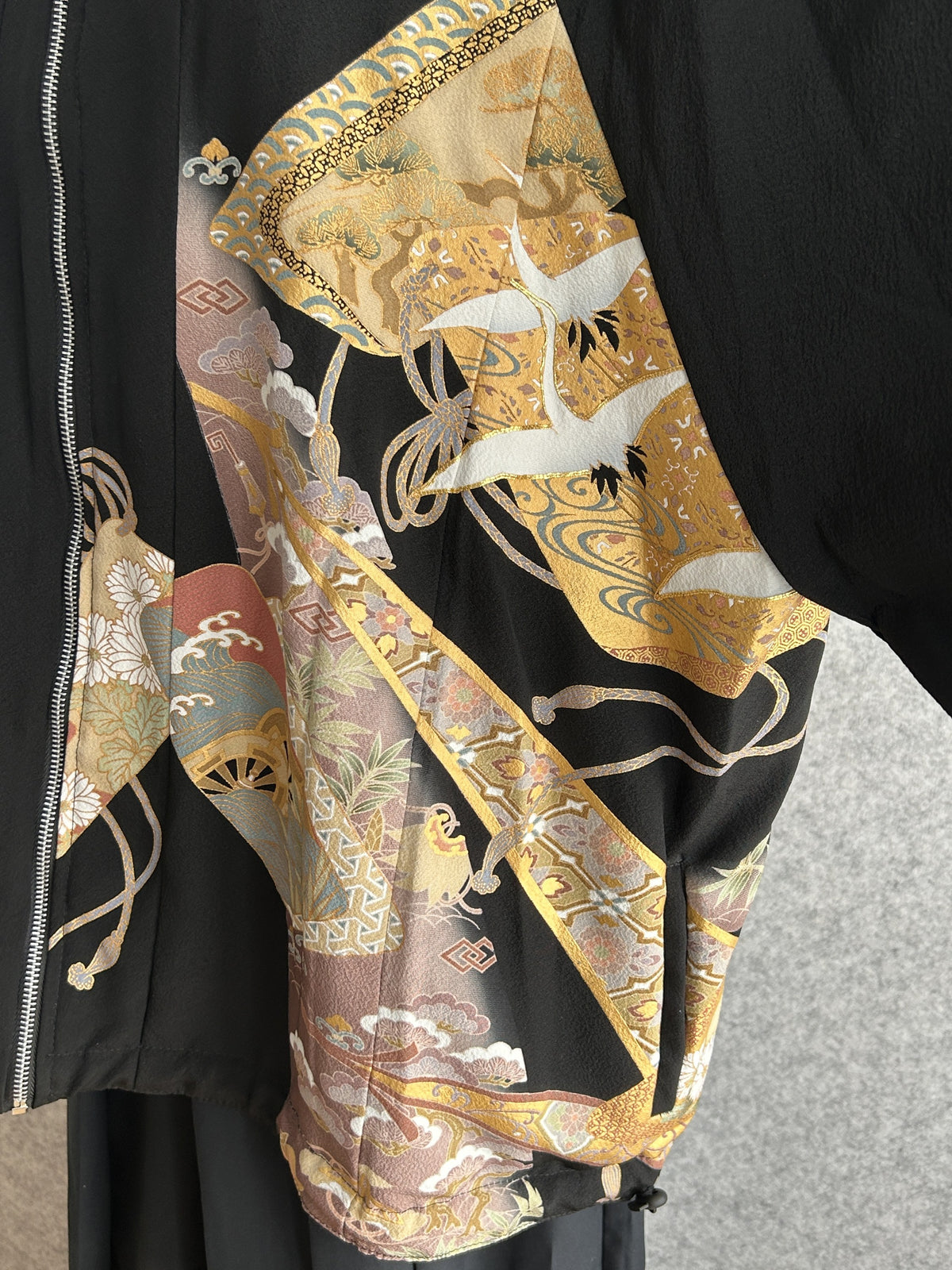 Black high collar kimono jacket with gold crane motifs, front detail with white cranes
