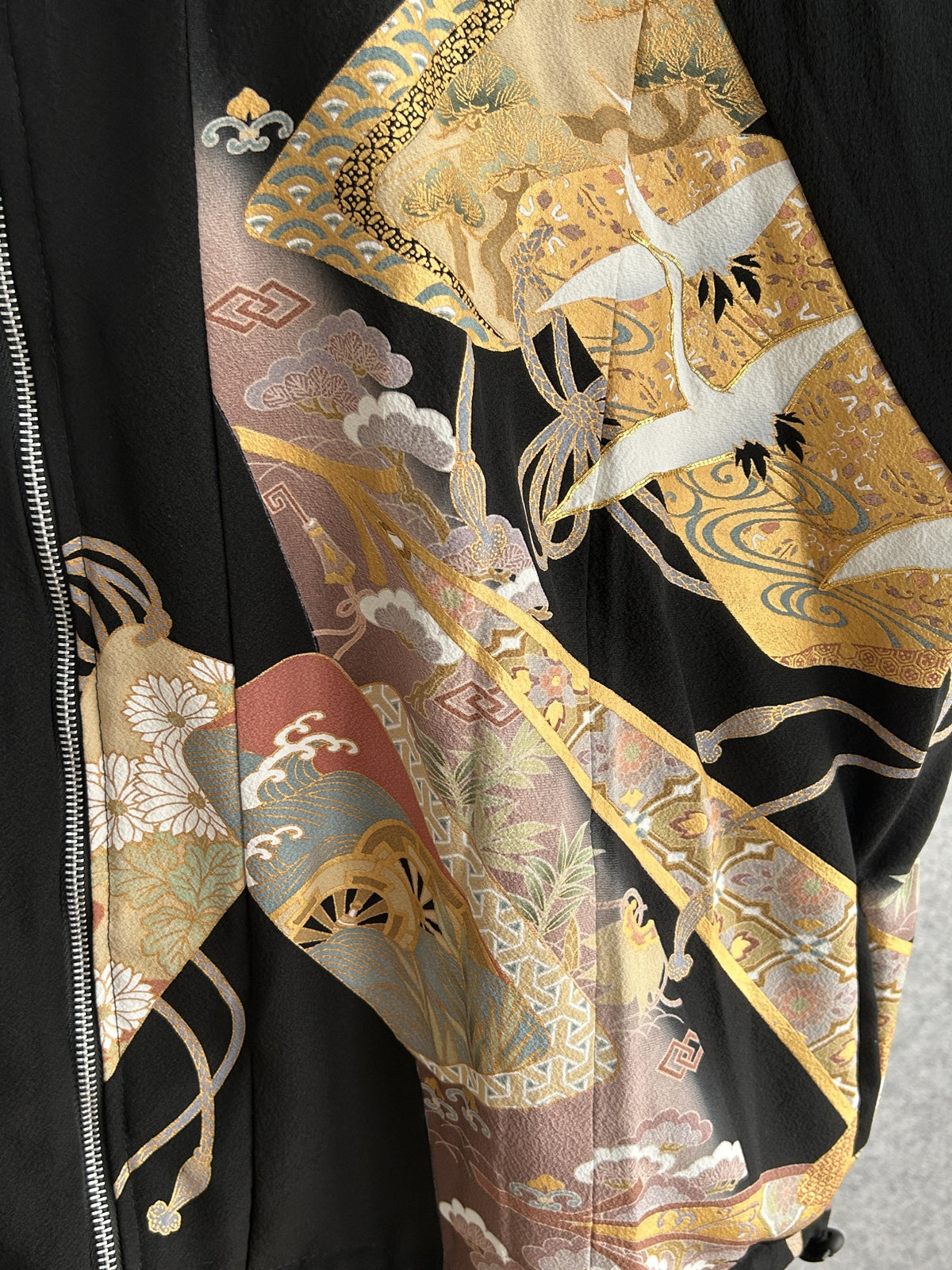 Black high collar kimono jacket with gold crane motifs, front motif beside the zipper