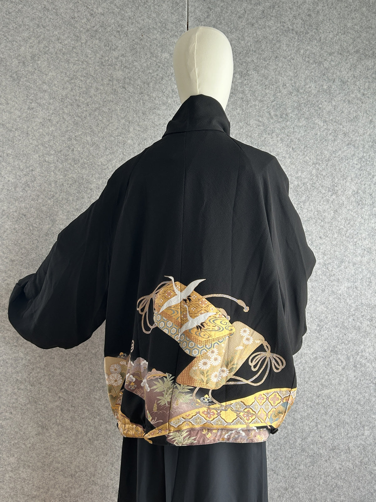 Black high collar kimono jacket with gold crane motifs, back view