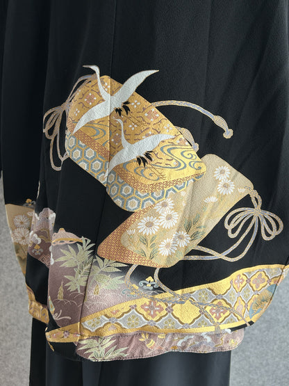 Black high collar kimono jacket with gold crane motifs, back hem detail with gold band and flowers