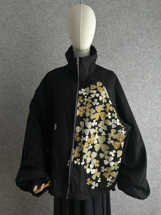 Black high collar kimono jacket with clover leaves, front view