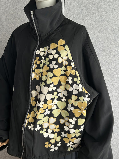 Black high collar kimono jacket with clover leaves, angled front view showing zipper and collar