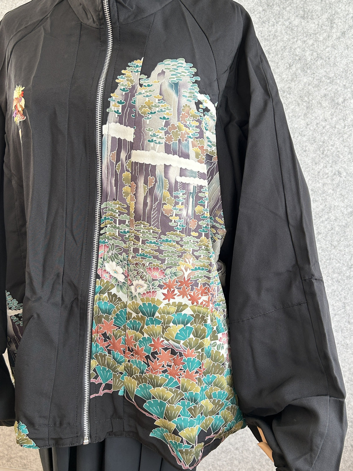Black high collar kimono jacket with landscape scene, closer front view