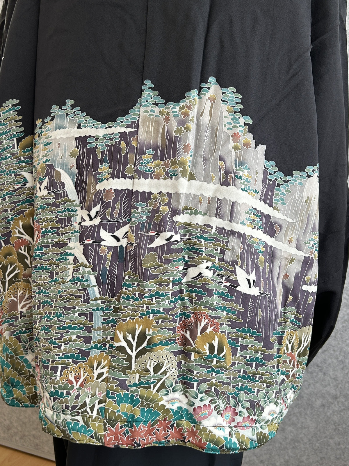 Black high collar kimono jacket with landscape scene, detail of the back with flying cranes