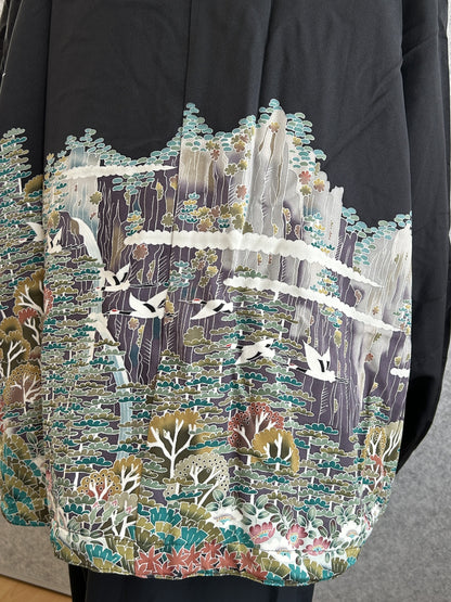 Black high collar kimono jacket with landscape scene, detail of the back with flying cranes