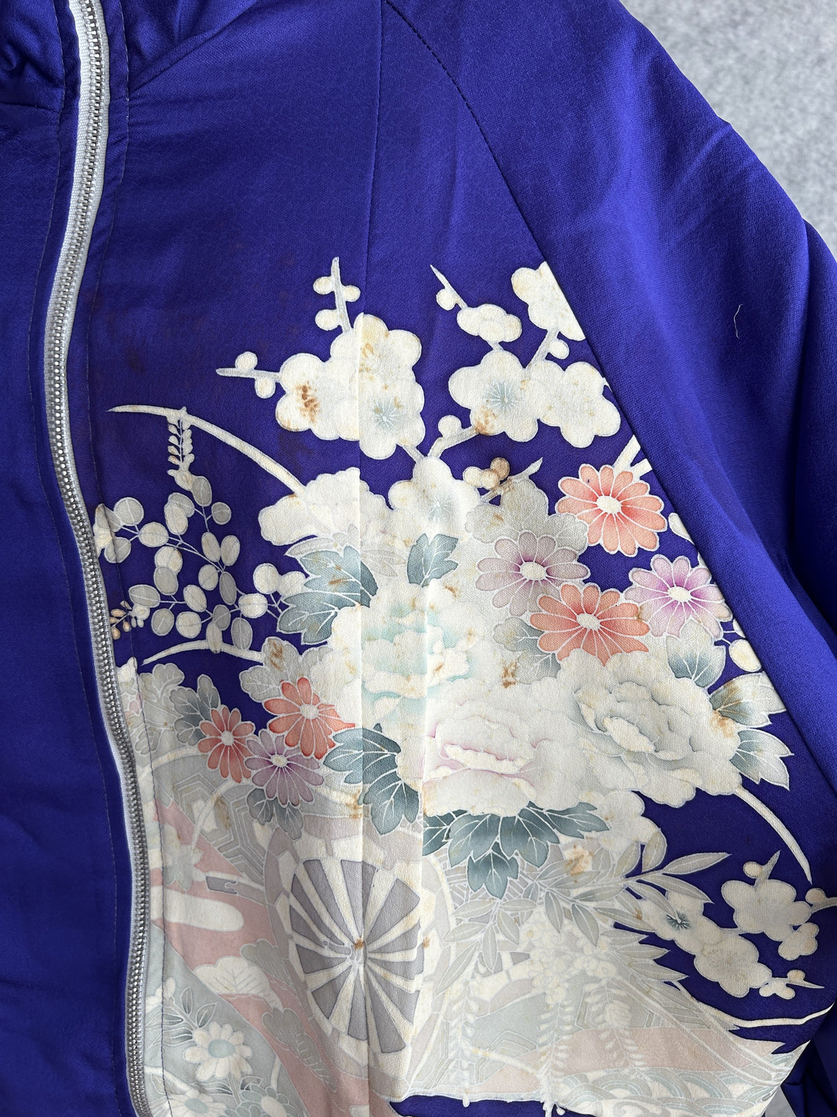 Purple kimono jacket, detail of white and coral flowers beside the zipper