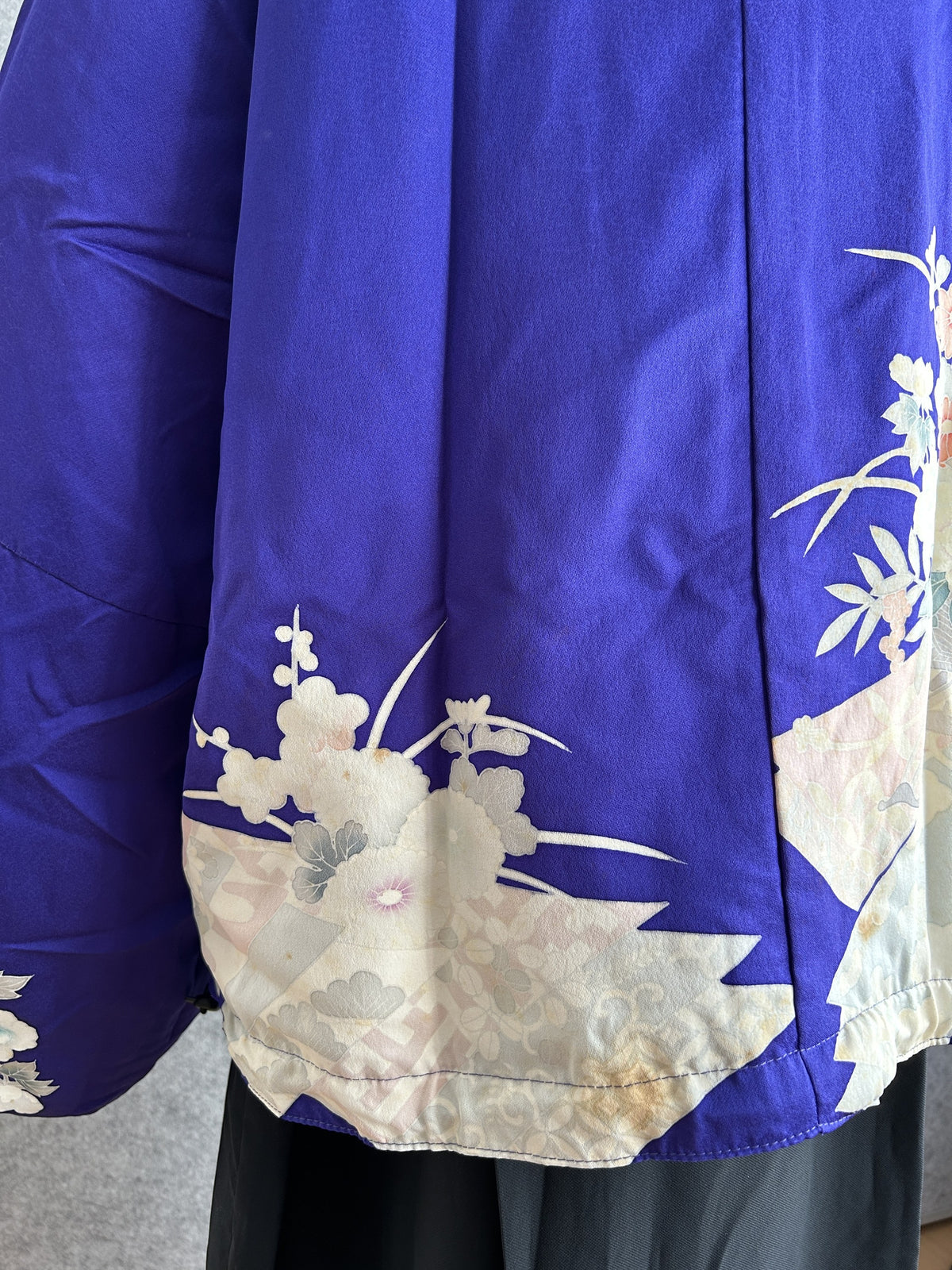 Purple kimono jacket, detail of cream patterned hem and side seam