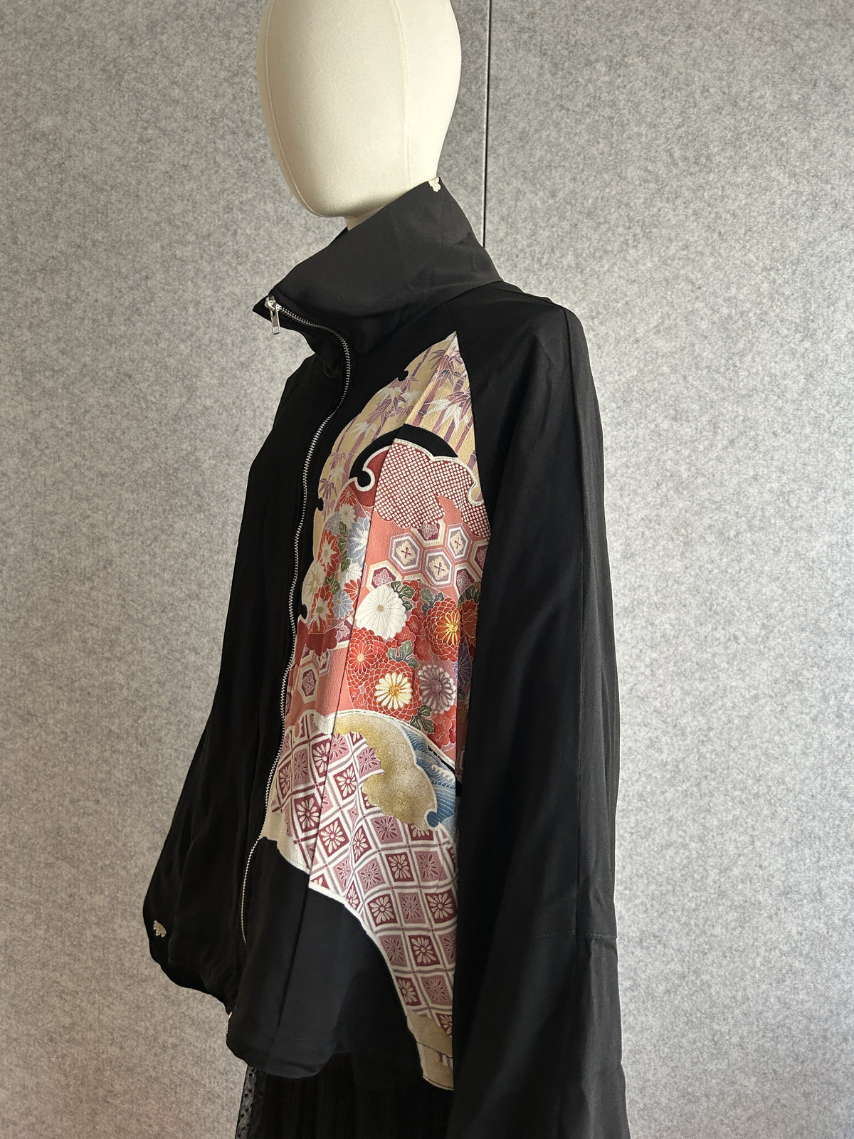 Black kimono jacket with red and pink floral panel, side view