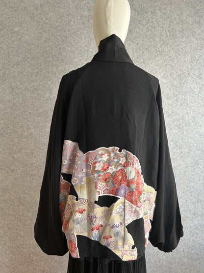 Black high collar kimono jacket with colourful floral panel, back view