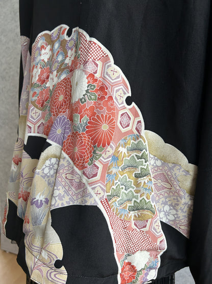 Black kimono jacket, detail of chrysanthemums and pine motif on back hem