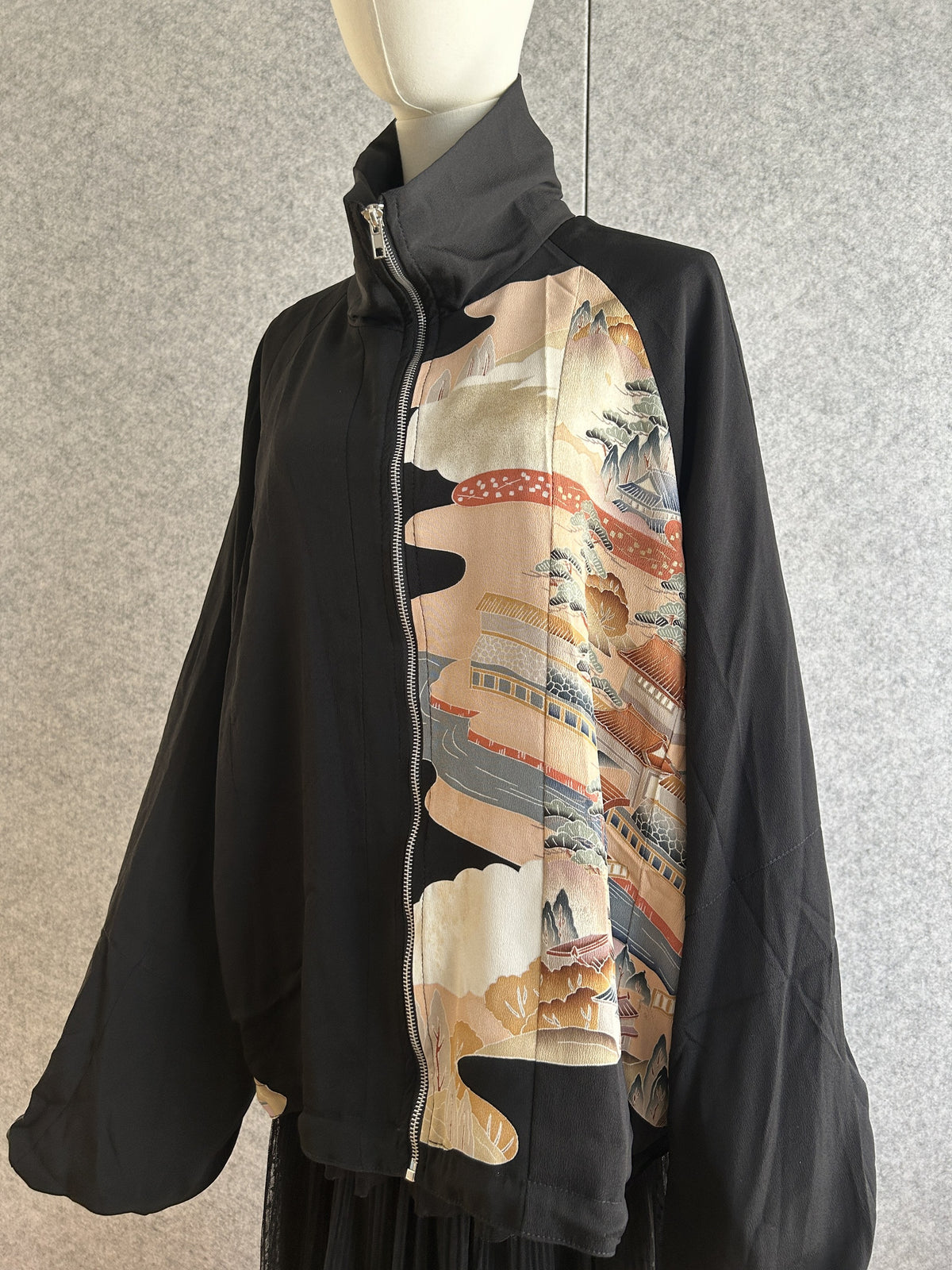 Black high collar kimono jacket with peach landscape panel, front side view
