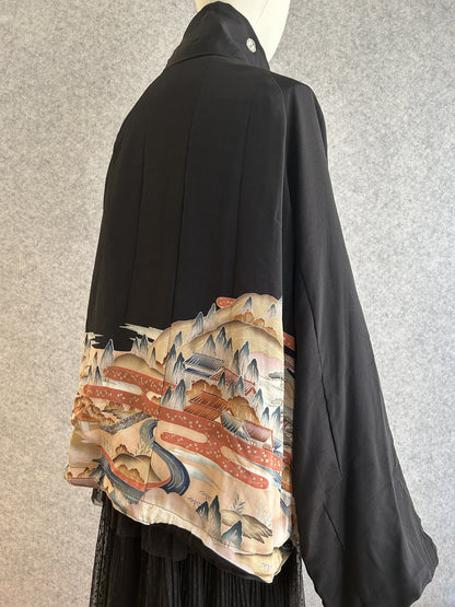 Black high collar kimono jacket with landscape scene at hem, side view