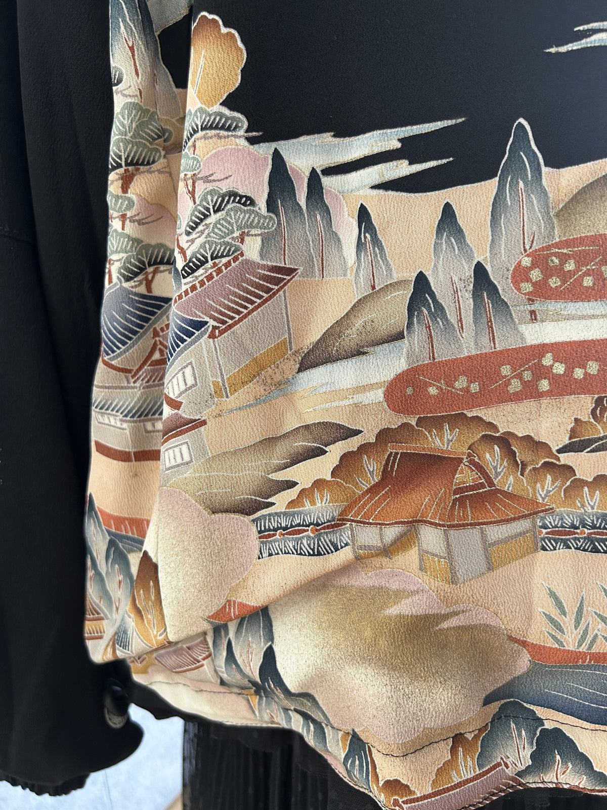 Black kimono jacket, detail of landscape scene at side hem
