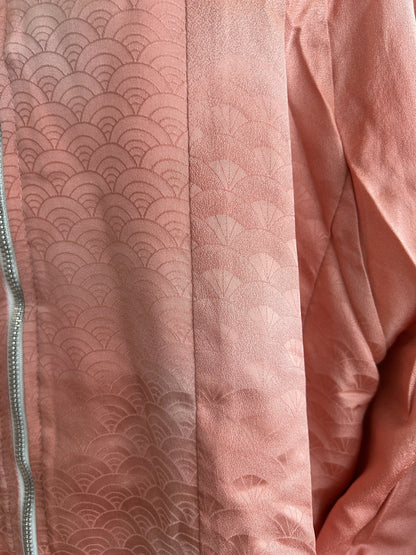 Pink kimono jacket, close-up of tone-on-tone wave pattern beside the zipper