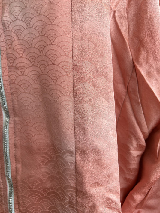 Pink kimono jacket, close-up of tone-on-tone wave pattern beside the zipper