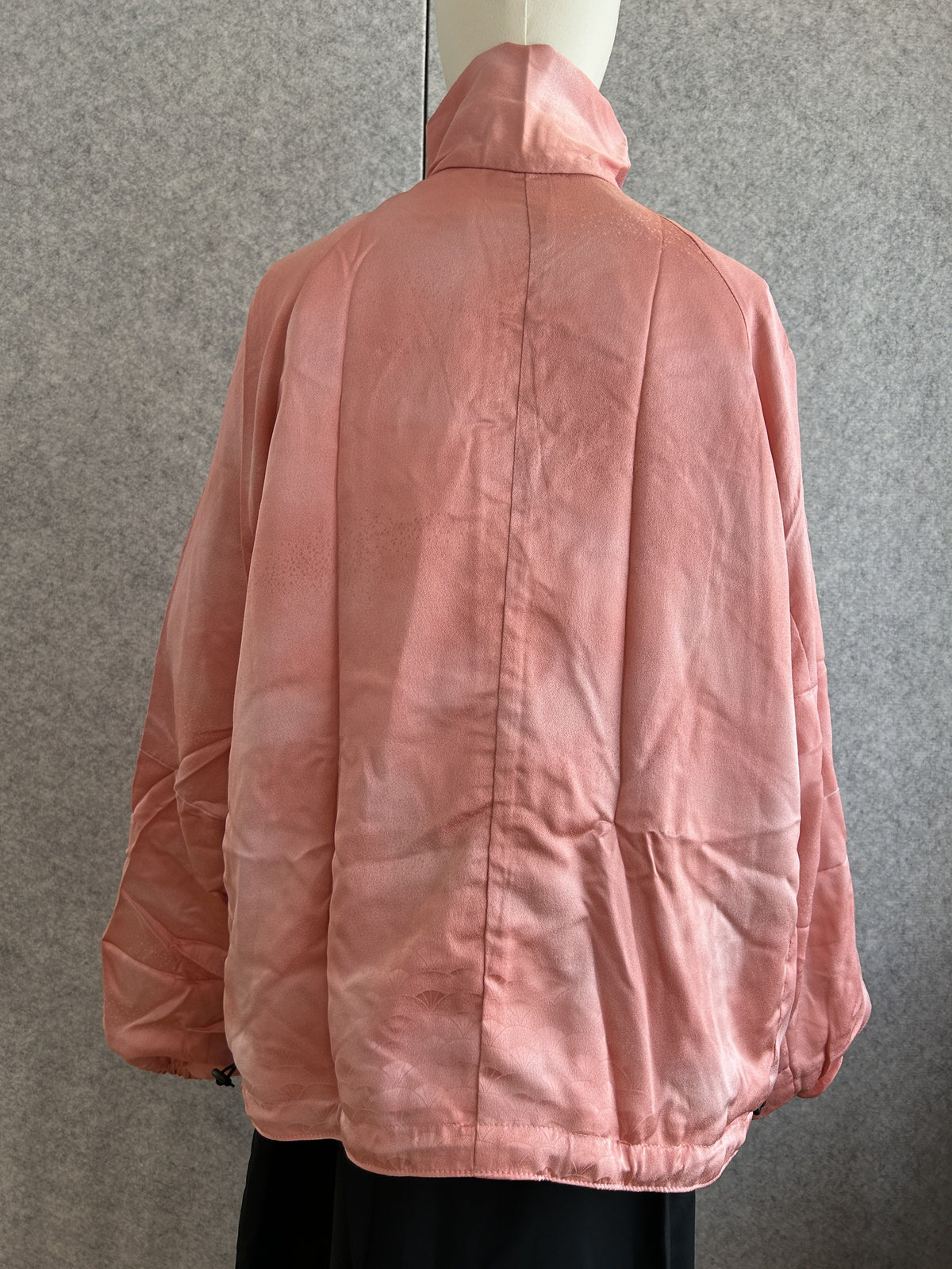 Pink high collar kimono jacket with subtle woven pattern, back view