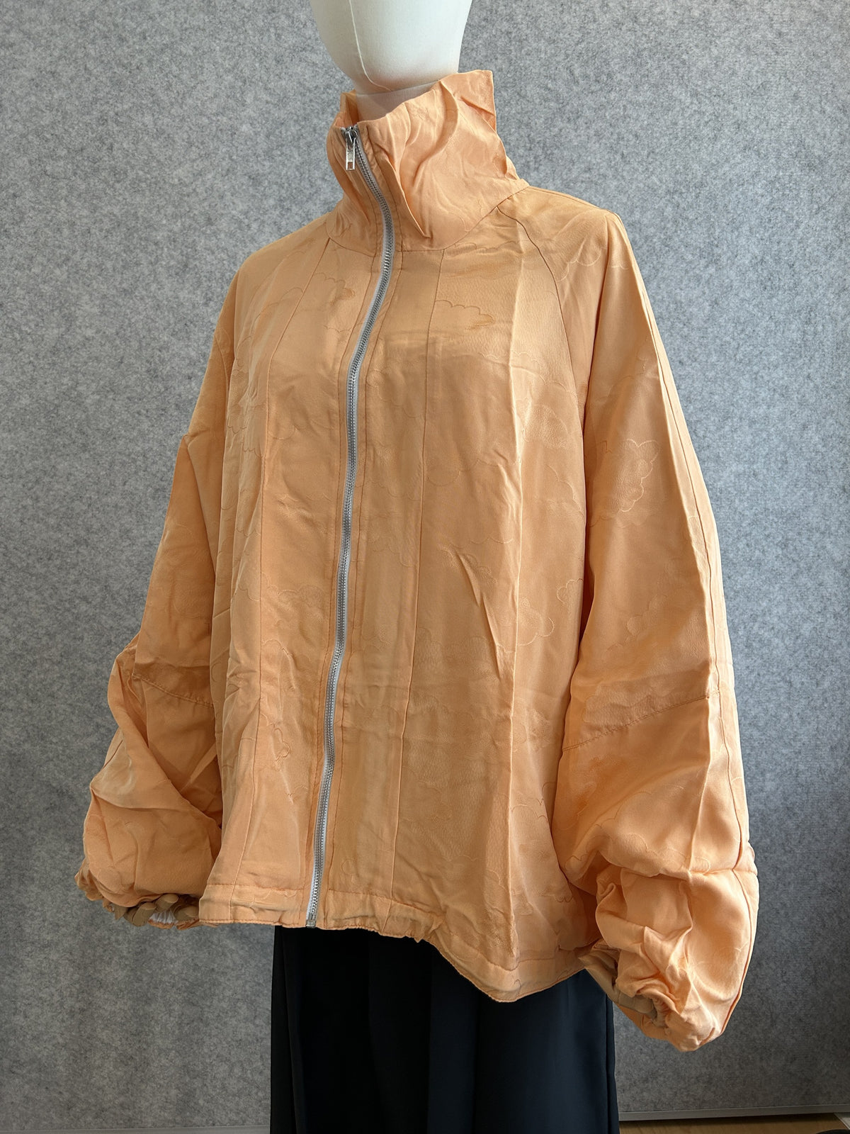 Light orange high collar kimono jacket with subtle cloud pattern, front view