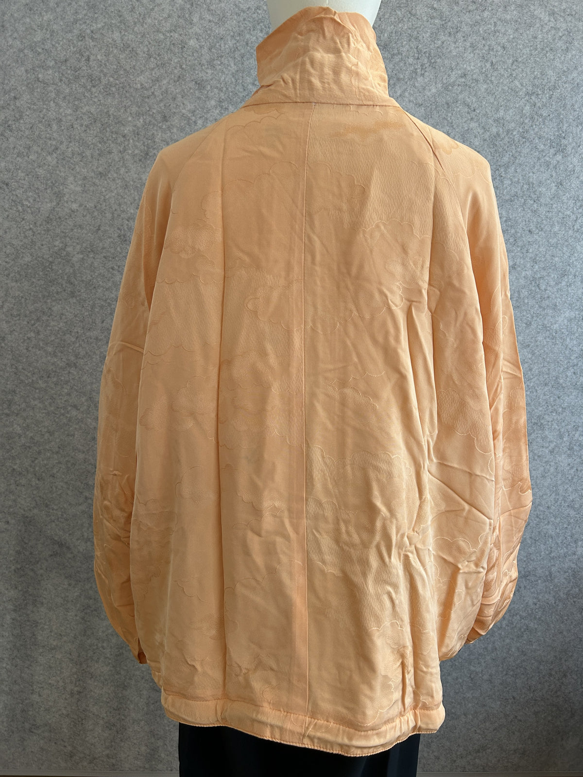 Light orange high collar kimono jacket with subtle cloud pattern, back view