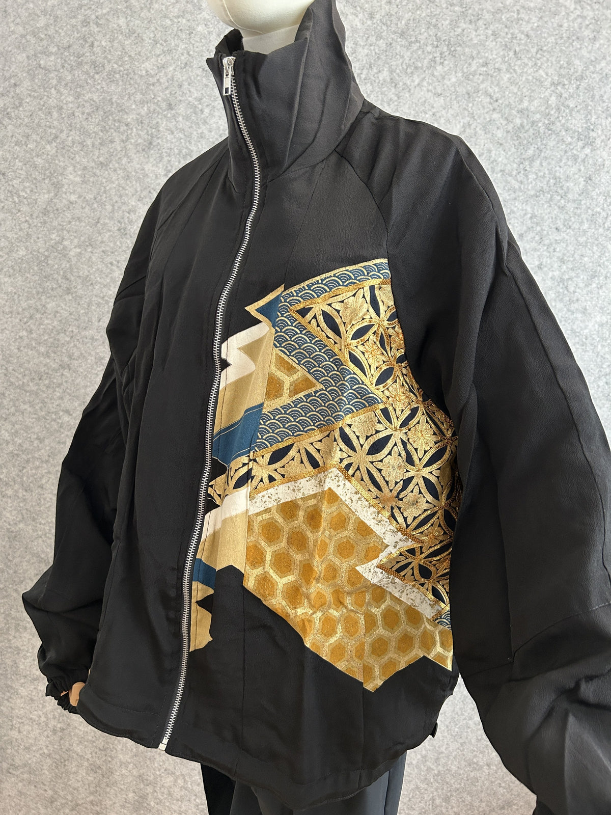 Black high collar kimono jacket with gold geometric panel, front side view