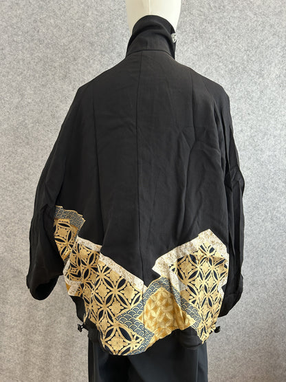 Black high collar kimono jacket with gold geometric hem panel, back view