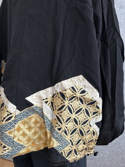 Black kimono jacket, close-up of gold and navy geometric panel on back