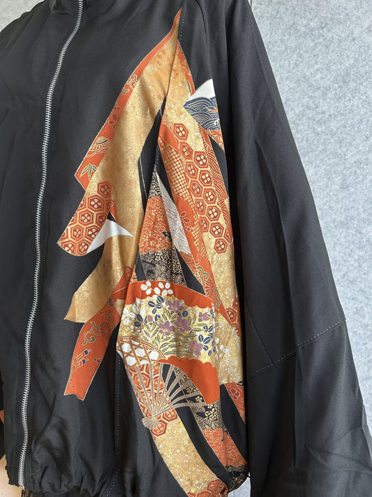 Black kimono jacket, close-up of orange and gold fan motifs on front
