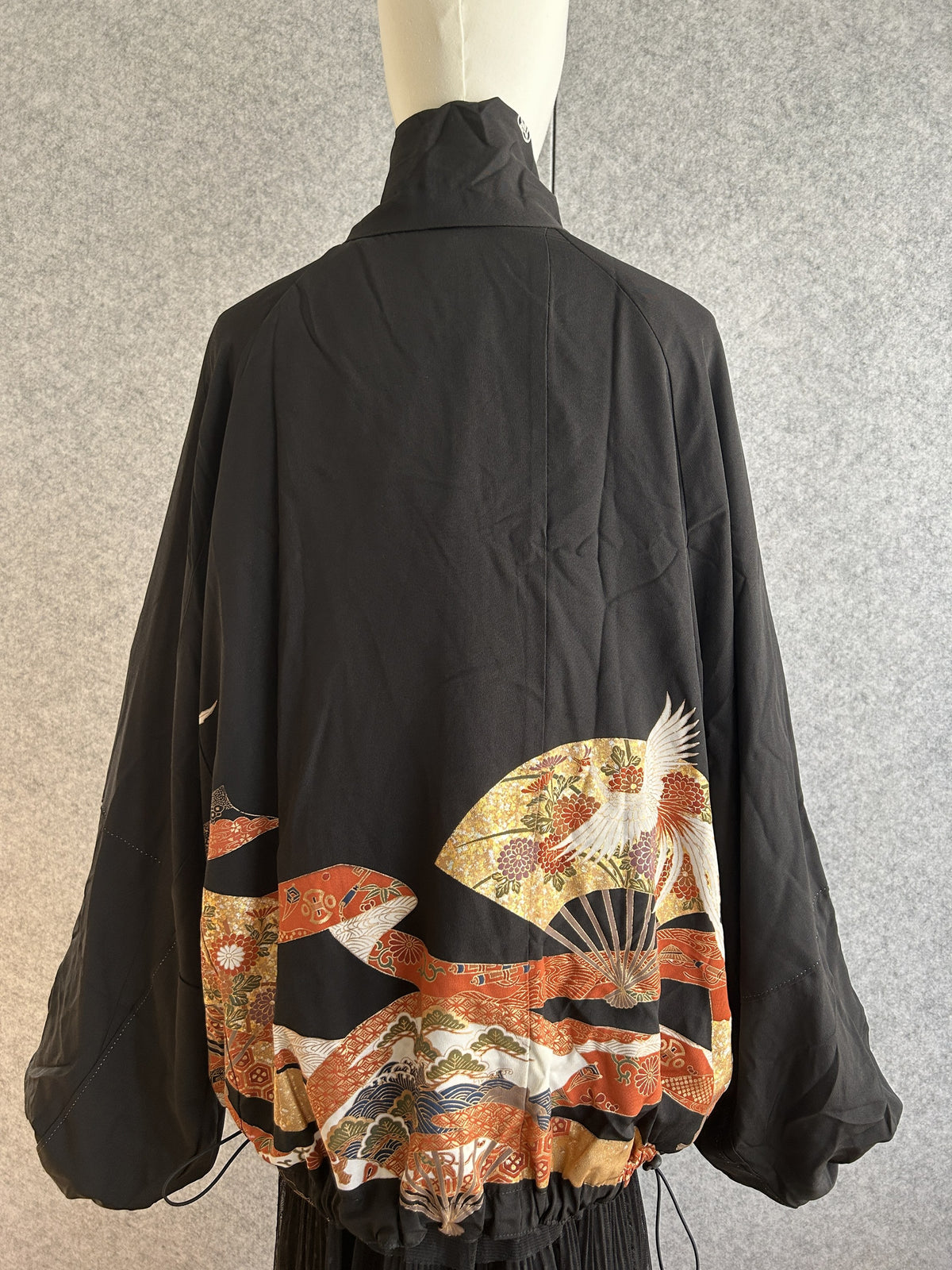 Black high collar kimono jacket with gold fan and crane, back view