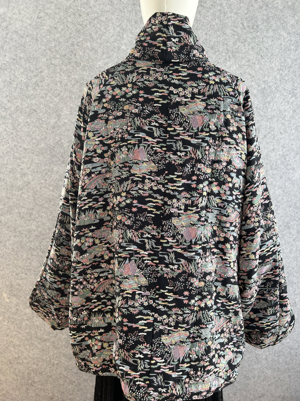 Black high collar kimono jacket with pastel all-over pattern, back view
