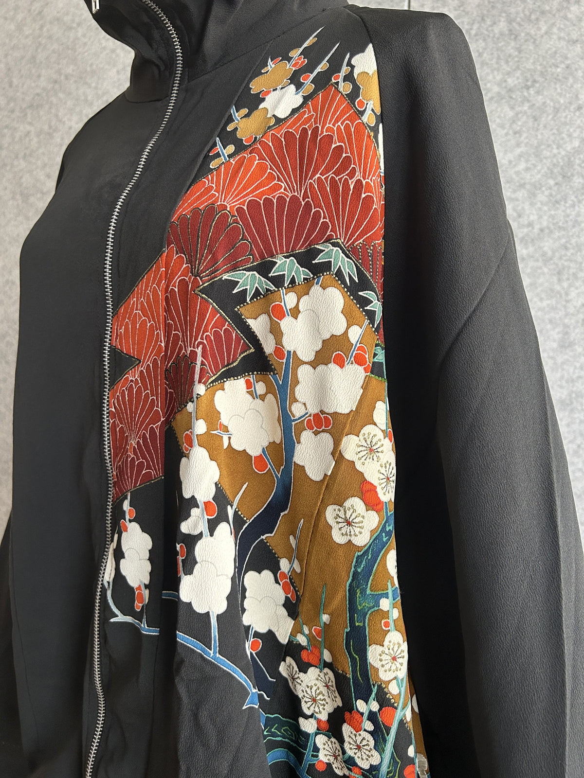 Black kimono jacket, close-up of white plum blossoms on gold front panel