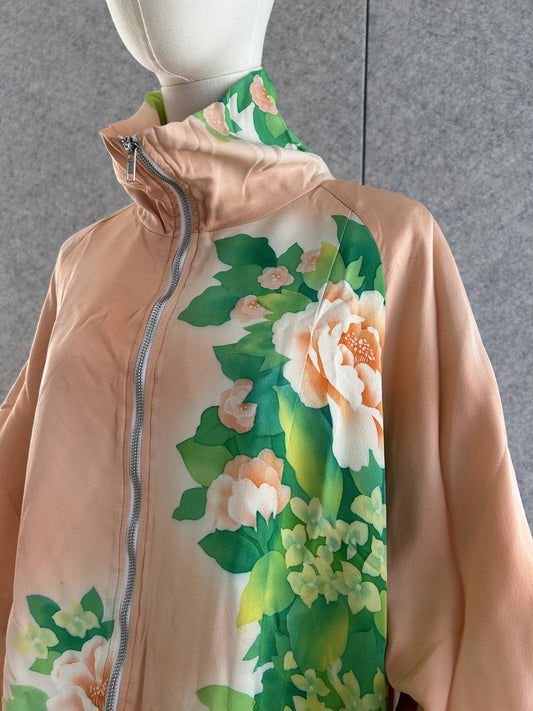 Peach kimono jacket with white flowers and green leaves, front close-up