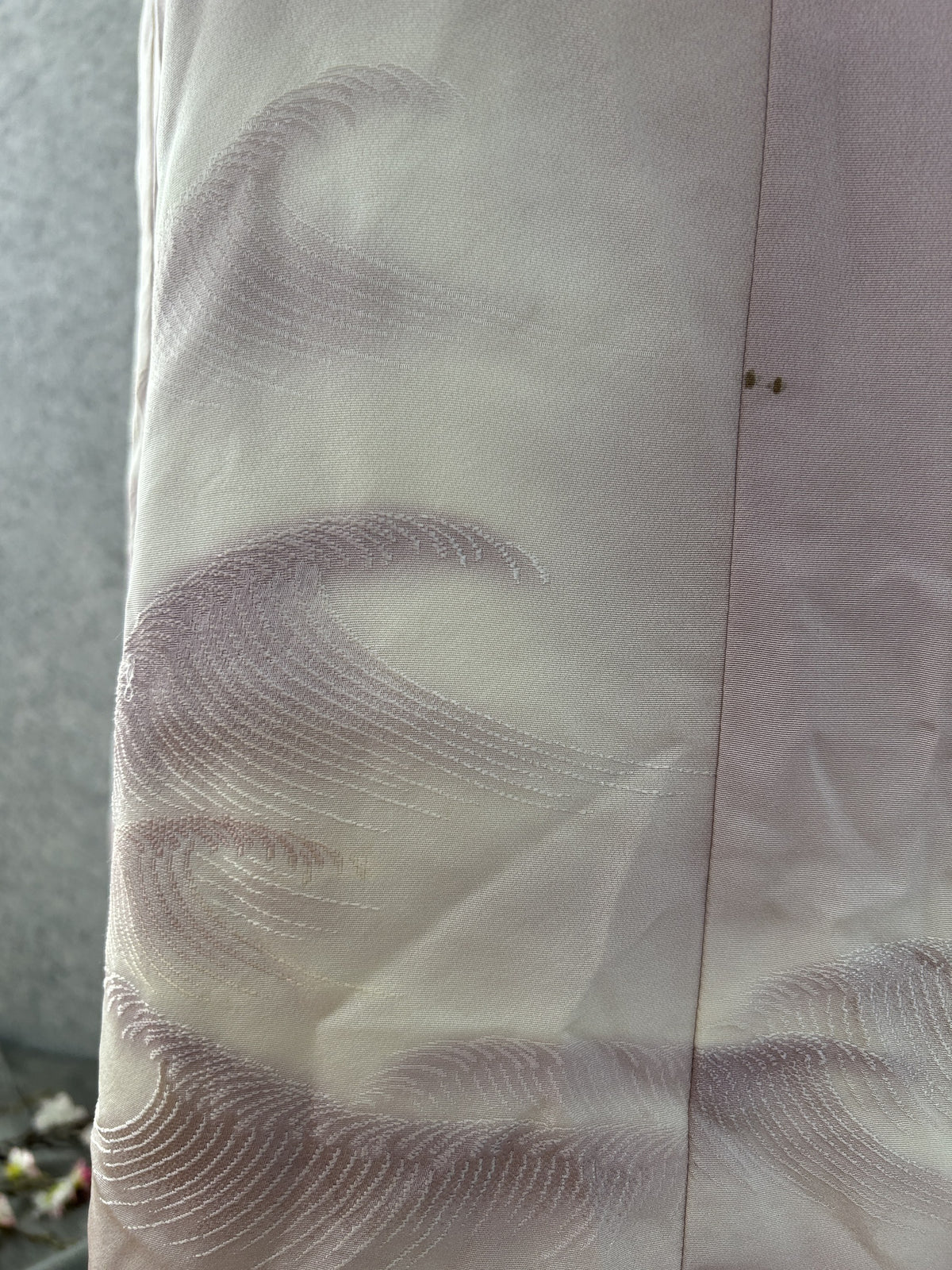 Close-up of stitched wave motif on lilac kimono silk