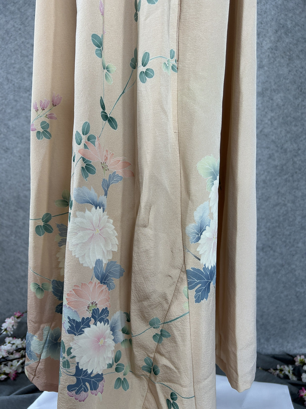 Side detail of peach kimono dress with chrysanthemums fading to dusty pink