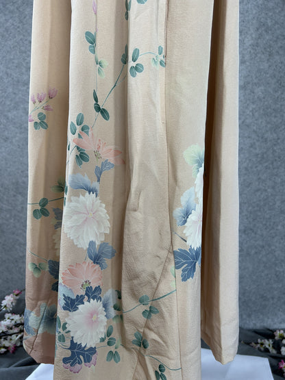 Side detail of peach kimono dress with chrysanthemums fading to dusty pink
