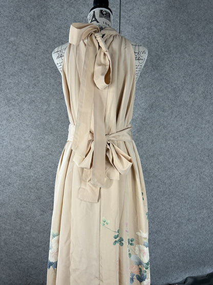 Back view of peach halter dress with neck ties and sash tied in a bow