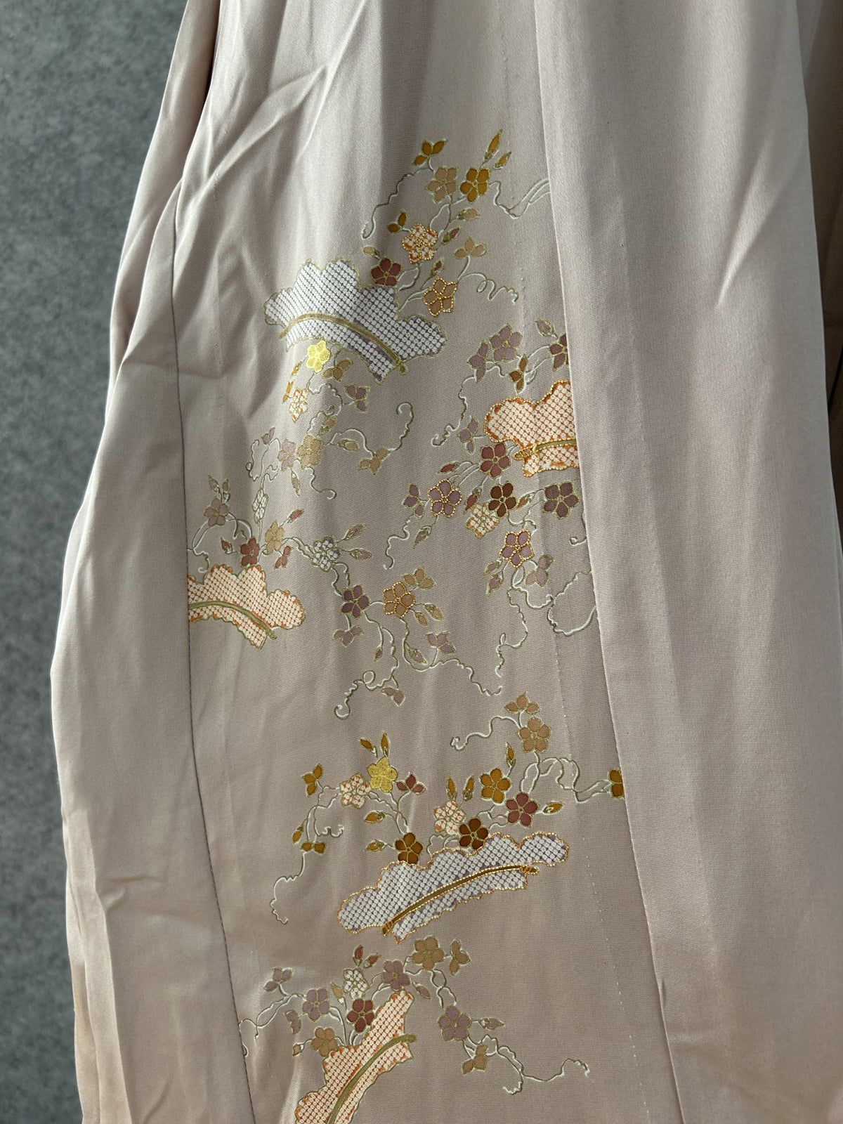 Detail of gold and mauve blossoms and lattice fans on beige kimono silk
