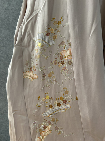 Detail of gold and mauve blossoms and lattice fans on beige kimono silk