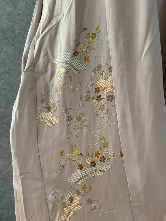 Detail of gold and mauve blossoms and lattice fans on beige kimono silk