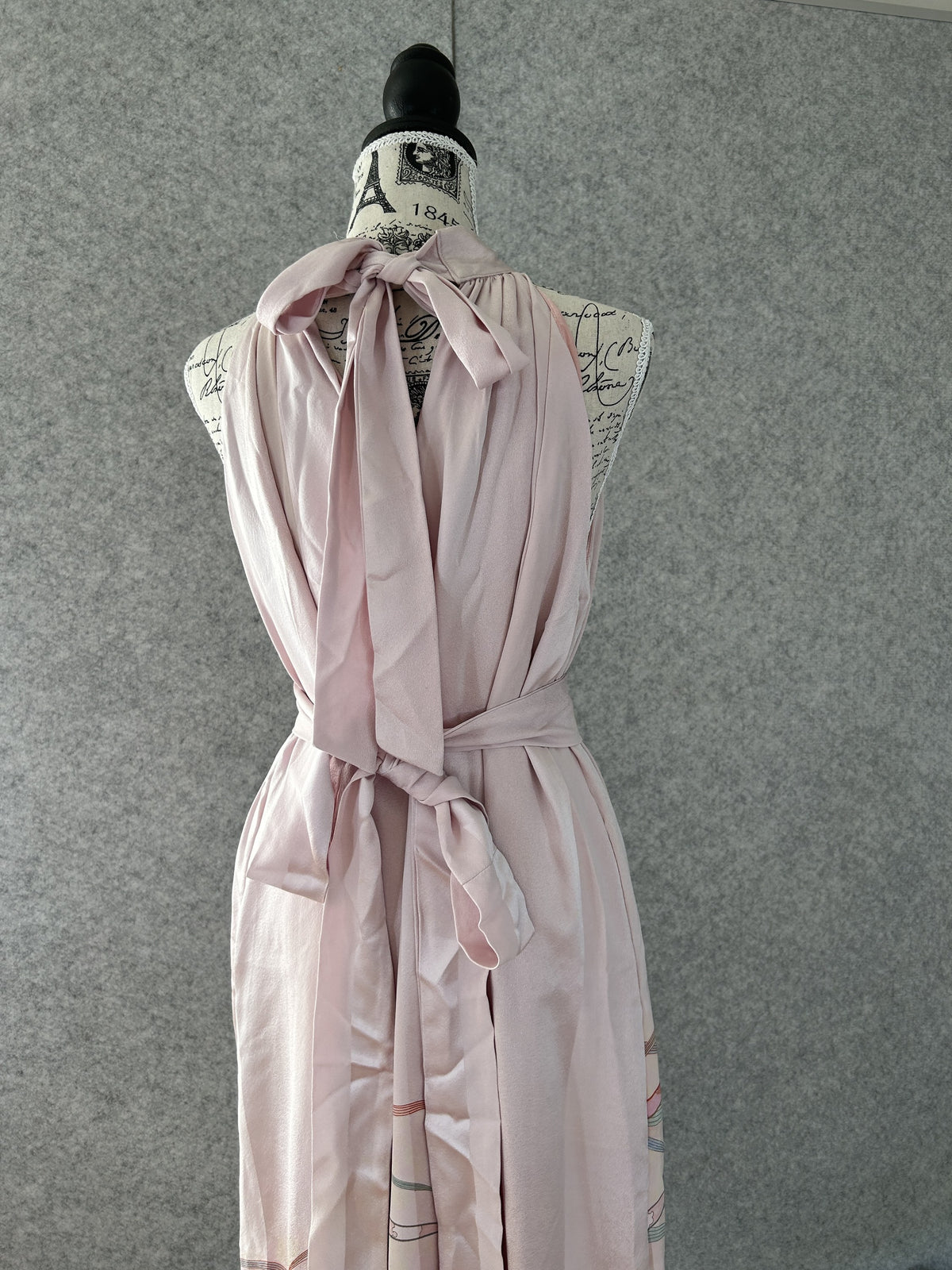 Light pink halter dress with neck bow and sash tied at the back